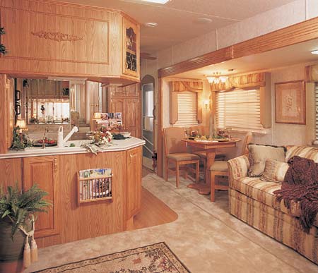 This 35 Quad Glide, in Dream Green designer decor, has a beautiful Island kitchen with large pantry, oval dining table with leaf, HAB sofa, and optional wood grain laminate flooring.
