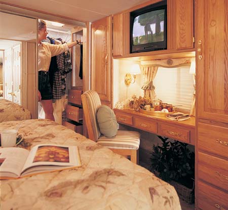 The 34+2 SK in Jade decor has residential cabinetry drawers, optional TV, and lots of storage, even a true walk-in closet with more drawers.